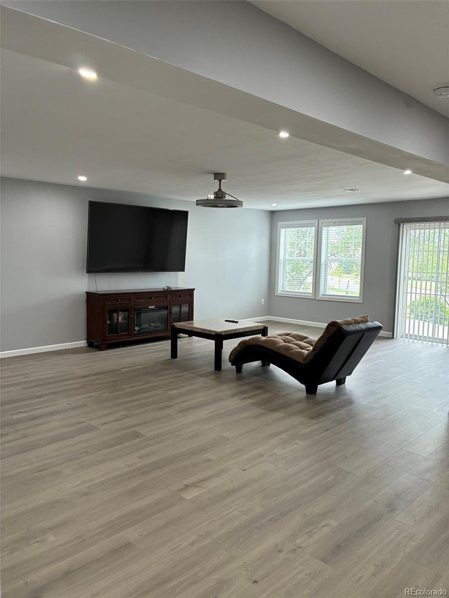 7242 South Rome Street Aurora, CO 80016 - Photo 18 of 33 a living room with furniture and a flat screen tv