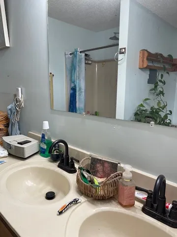 a bathroom with a double vanity sink and a mirror