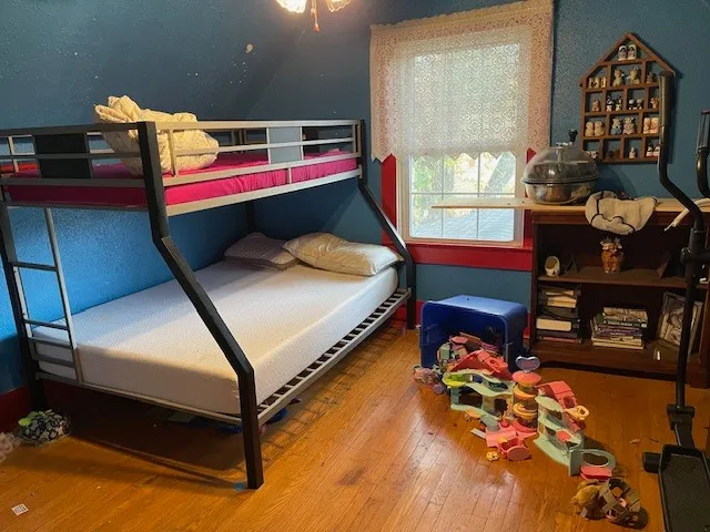 a bedroom with a bed and dresser