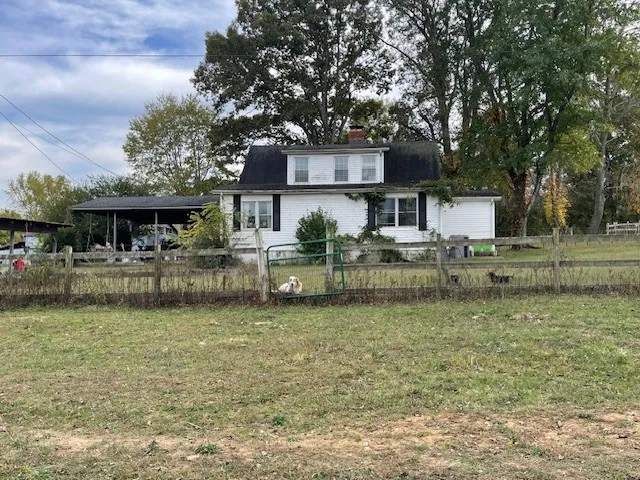 a front view of a house with a yard table and chairs