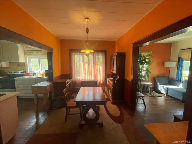 a dining room with furniture and a flat screen tv