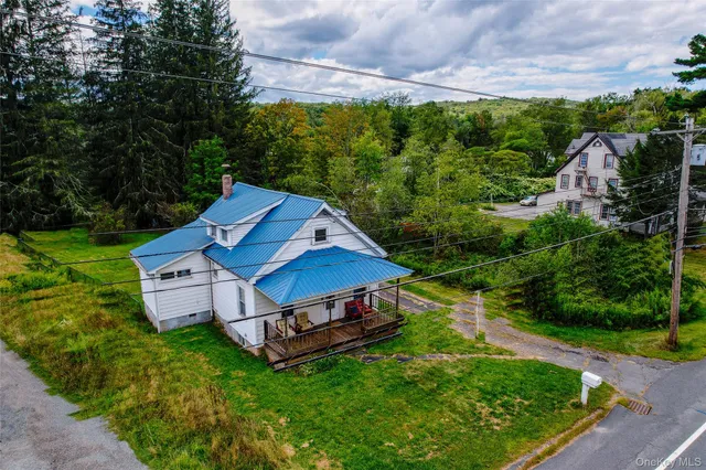 an aerial view of a house with backyard garden and outdoor seating