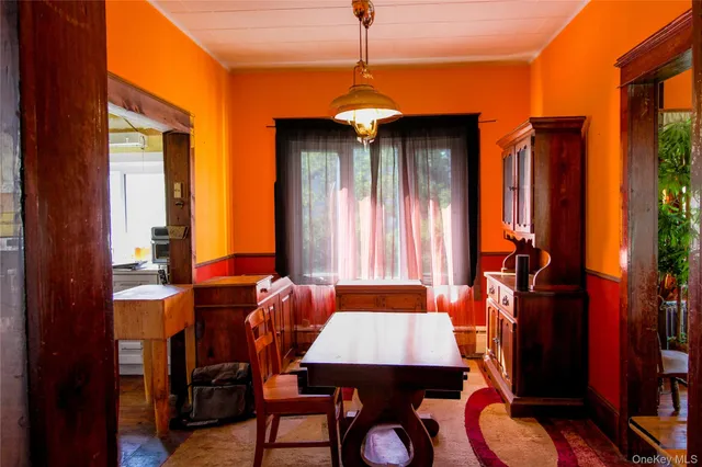 a dining room with furniture and window