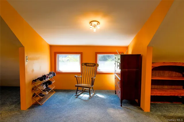 a bedroom with a bed chair and a window