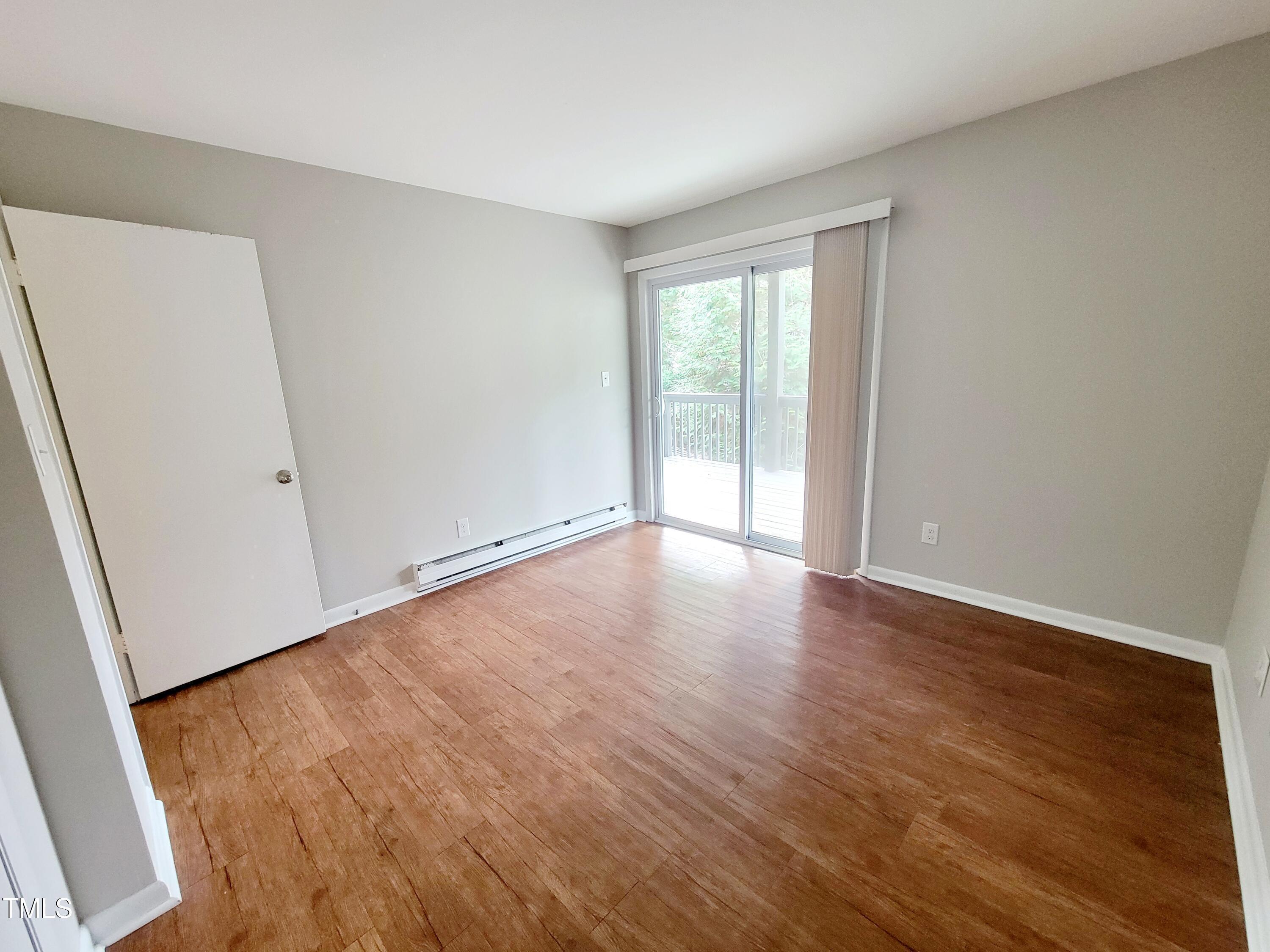 1422 Scales Street, Unit C Raleigh, NC 27608 - Photo 18 of 37 an empty room with wooden floor and windows