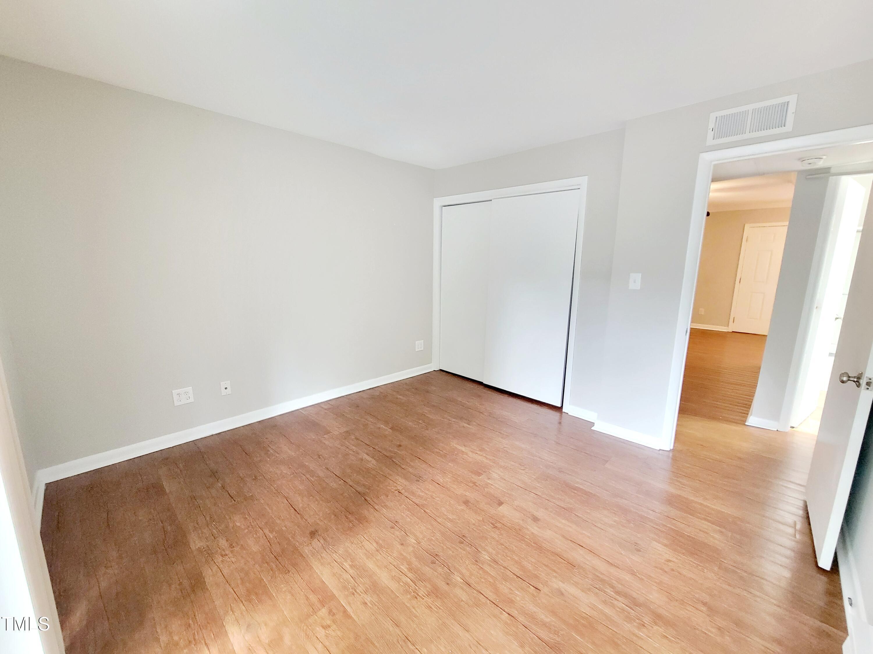 1422 Scales Street, Unit C Raleigh, NC 27608 - Photo 20 of 37 a view of an empty room and wooden floor