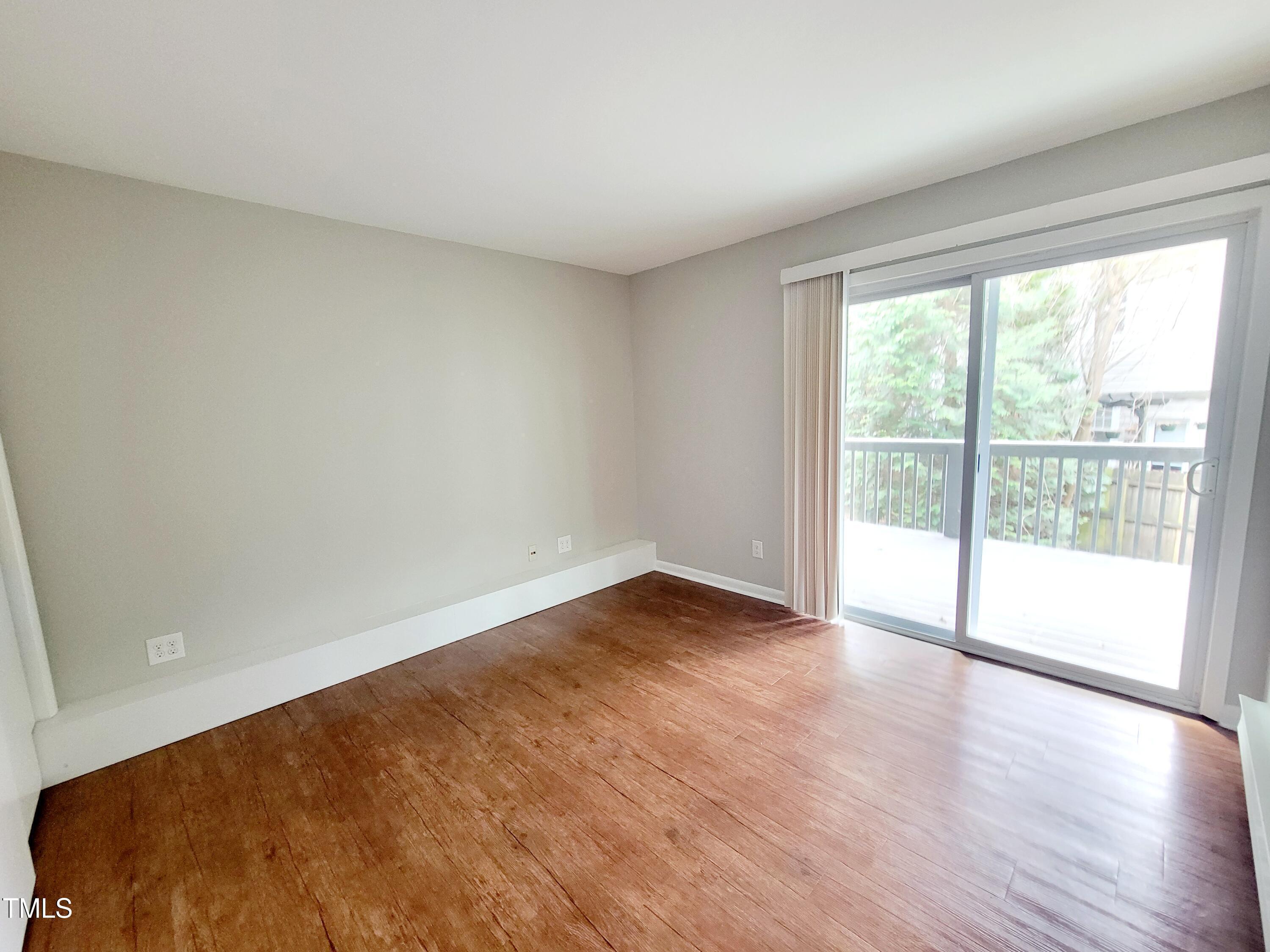 1422 Scales Street, Unit C Raleigh, NC 27608 - Photo 23 of 37 a view of an empty room with wooden floor and a window