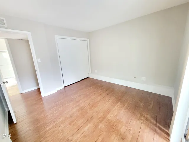 an empty room with wooden floor