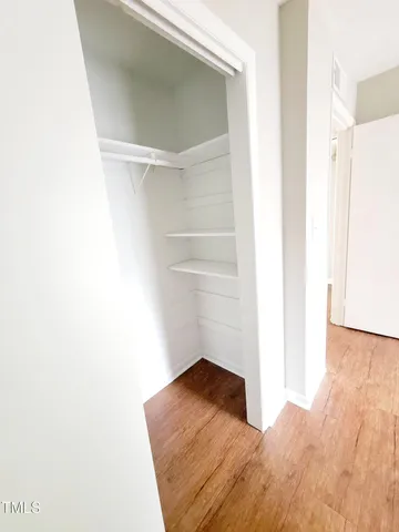 a view of a room with wooden floor