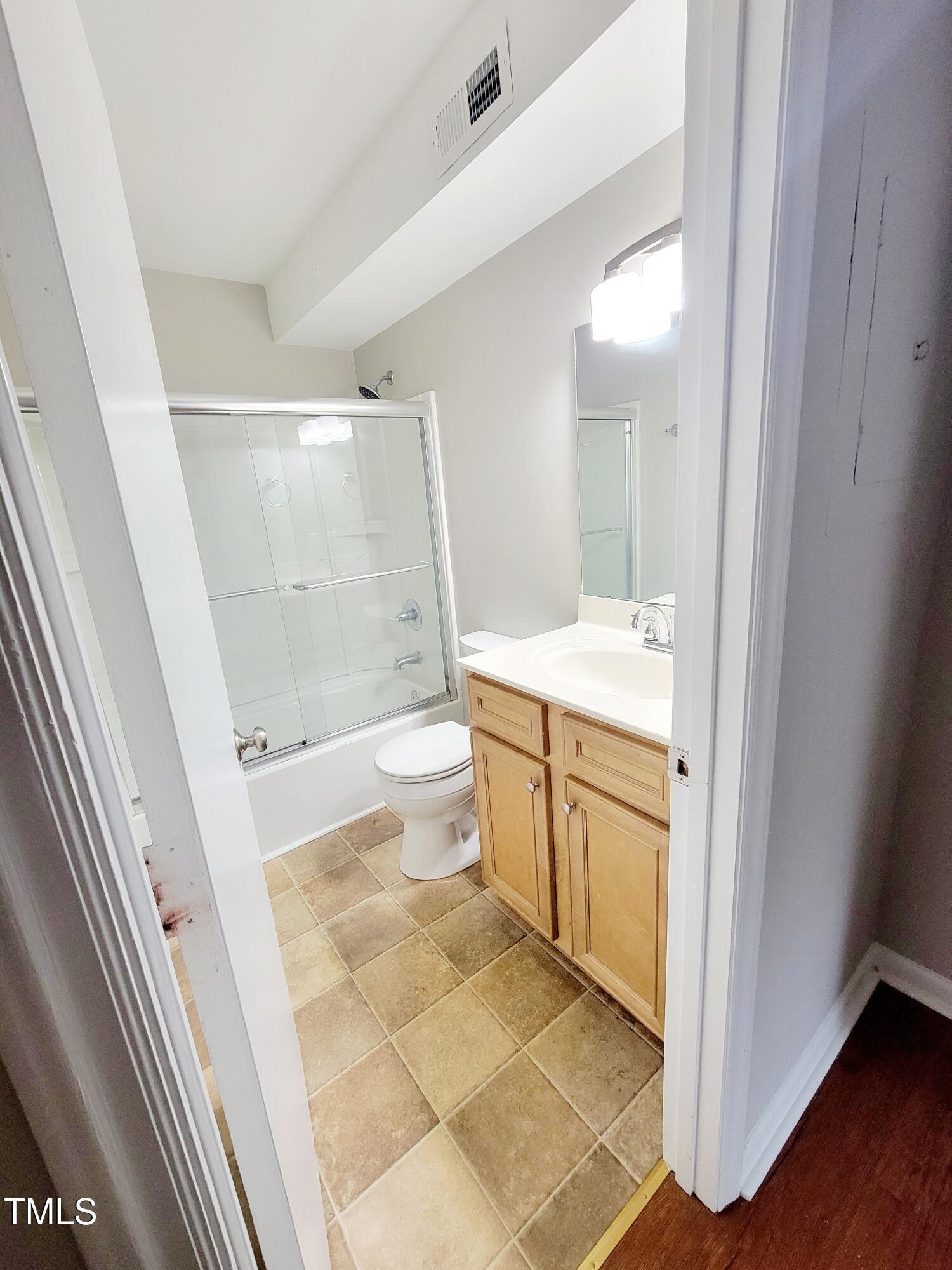 1422 Scales Street, Unit C Raleigh, NC 27608 - Photo 30 of 37 a bathroom with a granite countertop sink toilet and shower