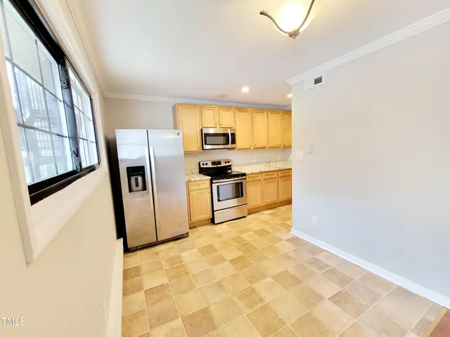 a kitchen with stainless steel appliances granite countertop a refrigerator and a sink