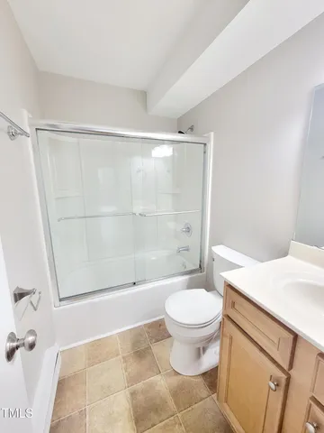 a bathroom with a shower a toilet and a sink
