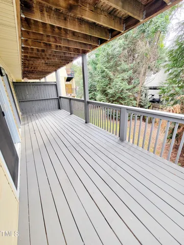 a view of balcony with wooden floor