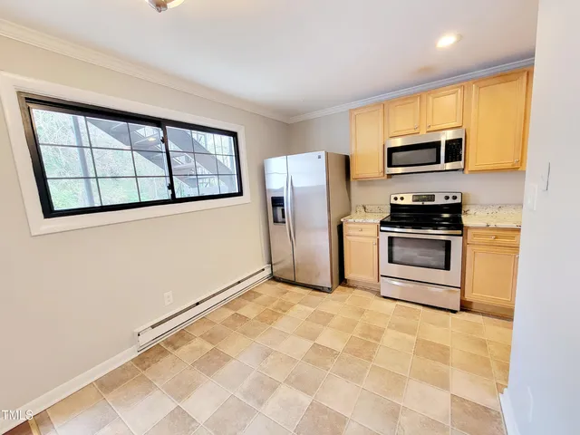 a kitchen with stainless steel appliances a refrigerator sink and microwave