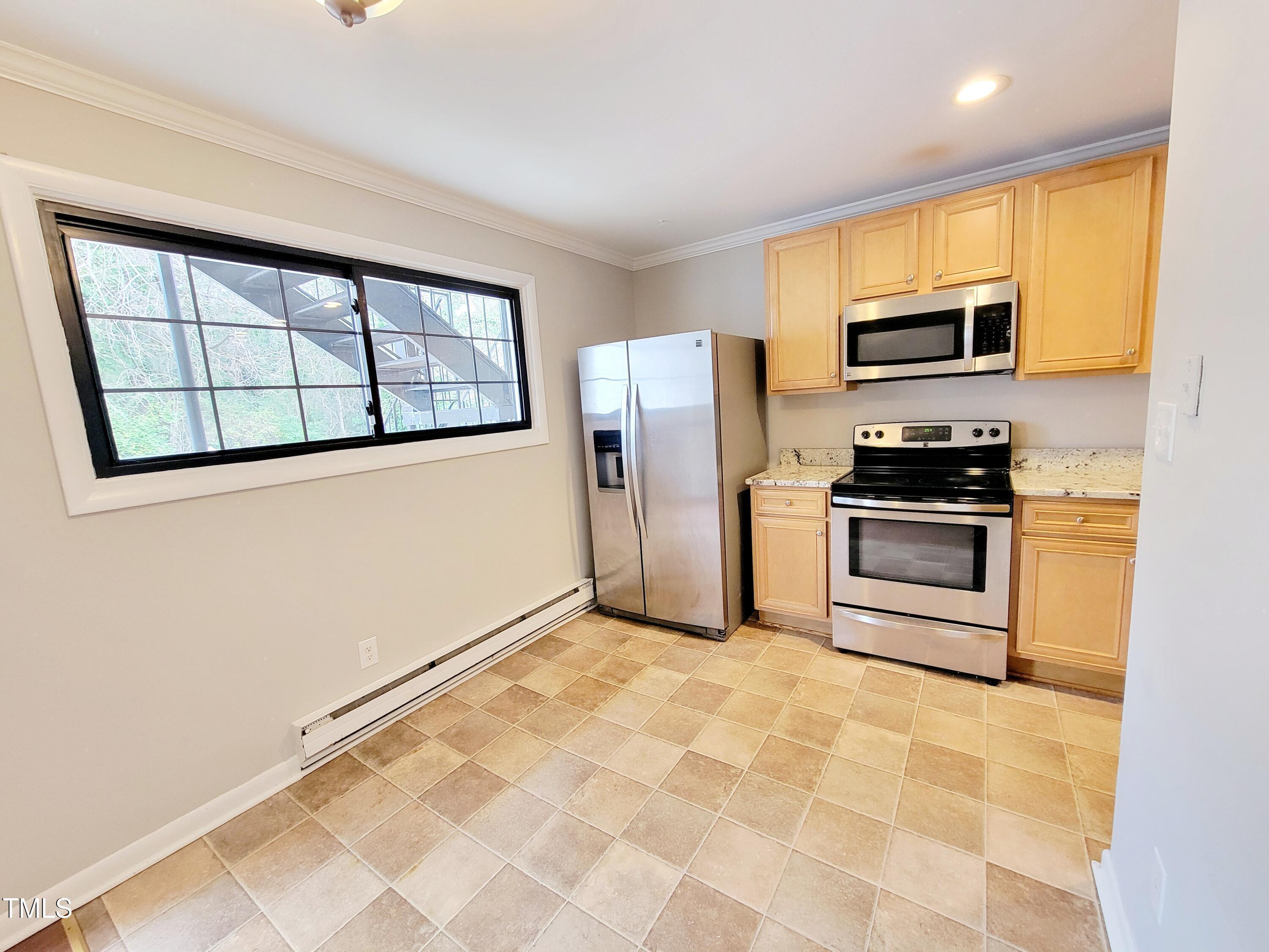 1422 Scales Street, Unit C Raleigh, NC 27608 - Photo 4 of 37 a kitchen with stainless steel appliances a refrigerator sink and microwave