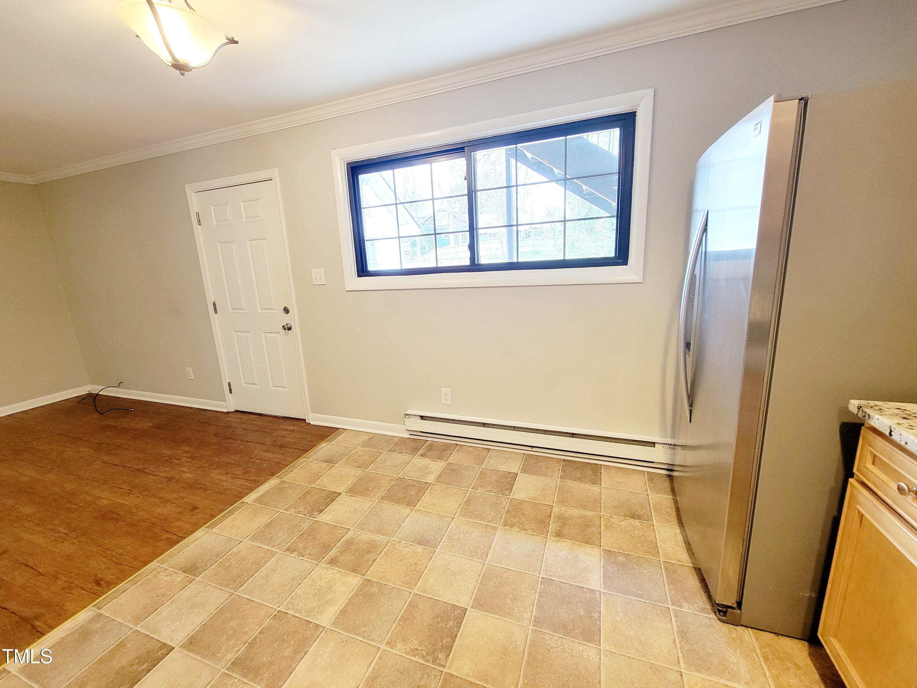 1422 Scales Street, Unit C Raleigh, NC 27608 - Photo 5 of 37 a view of an empty room with wooden floor and a window