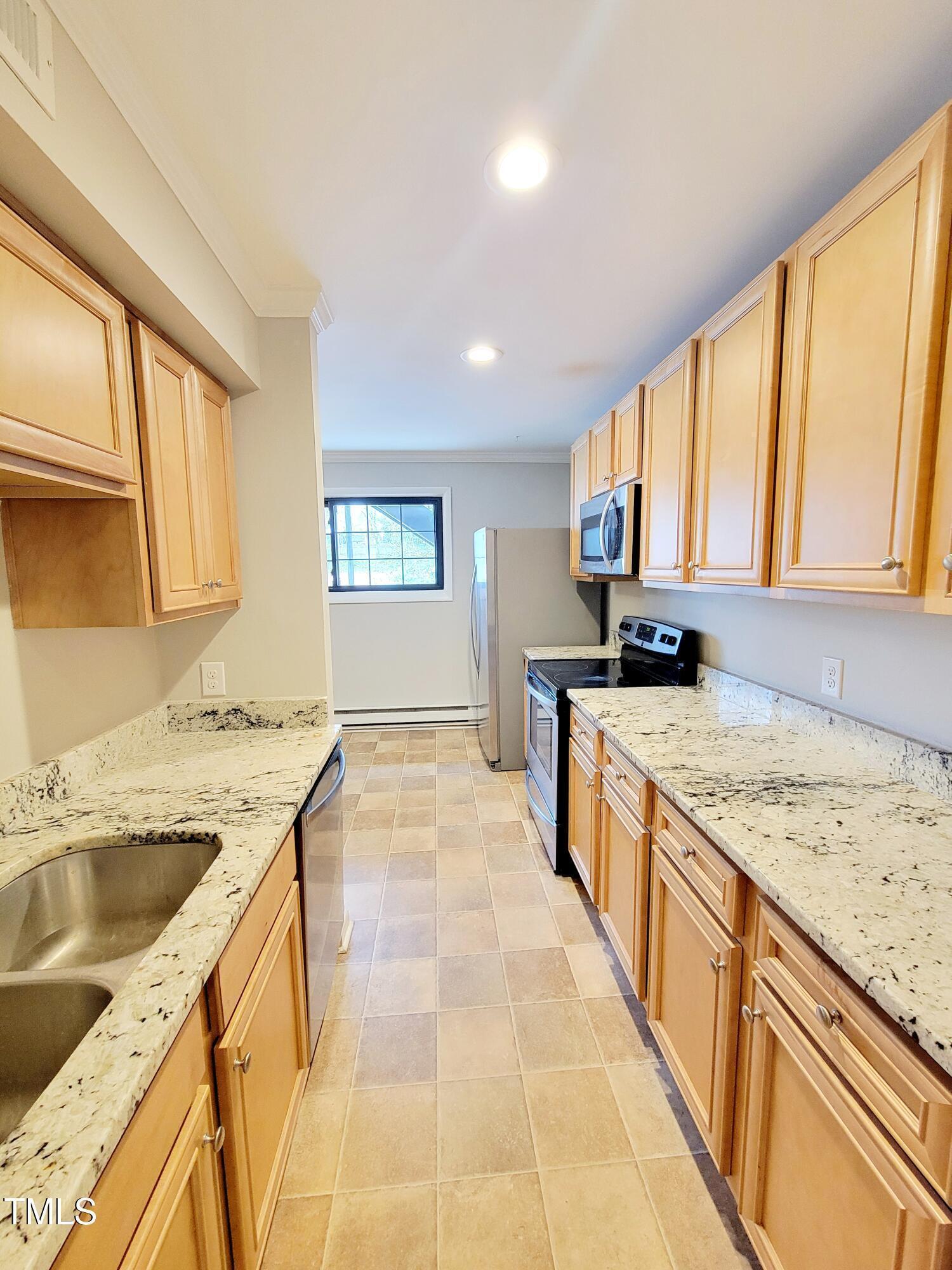 1422 Scales Street, Unit C Raleigh, NC 27608 - Photo 9 of 37 a large kitchen with a stove top oven a sink a counter space and cabinets