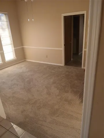 an empty room with a empty space and windows