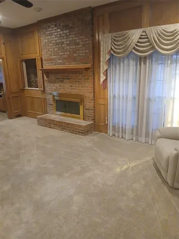 a view of a livingroom with furniture and a fireplace