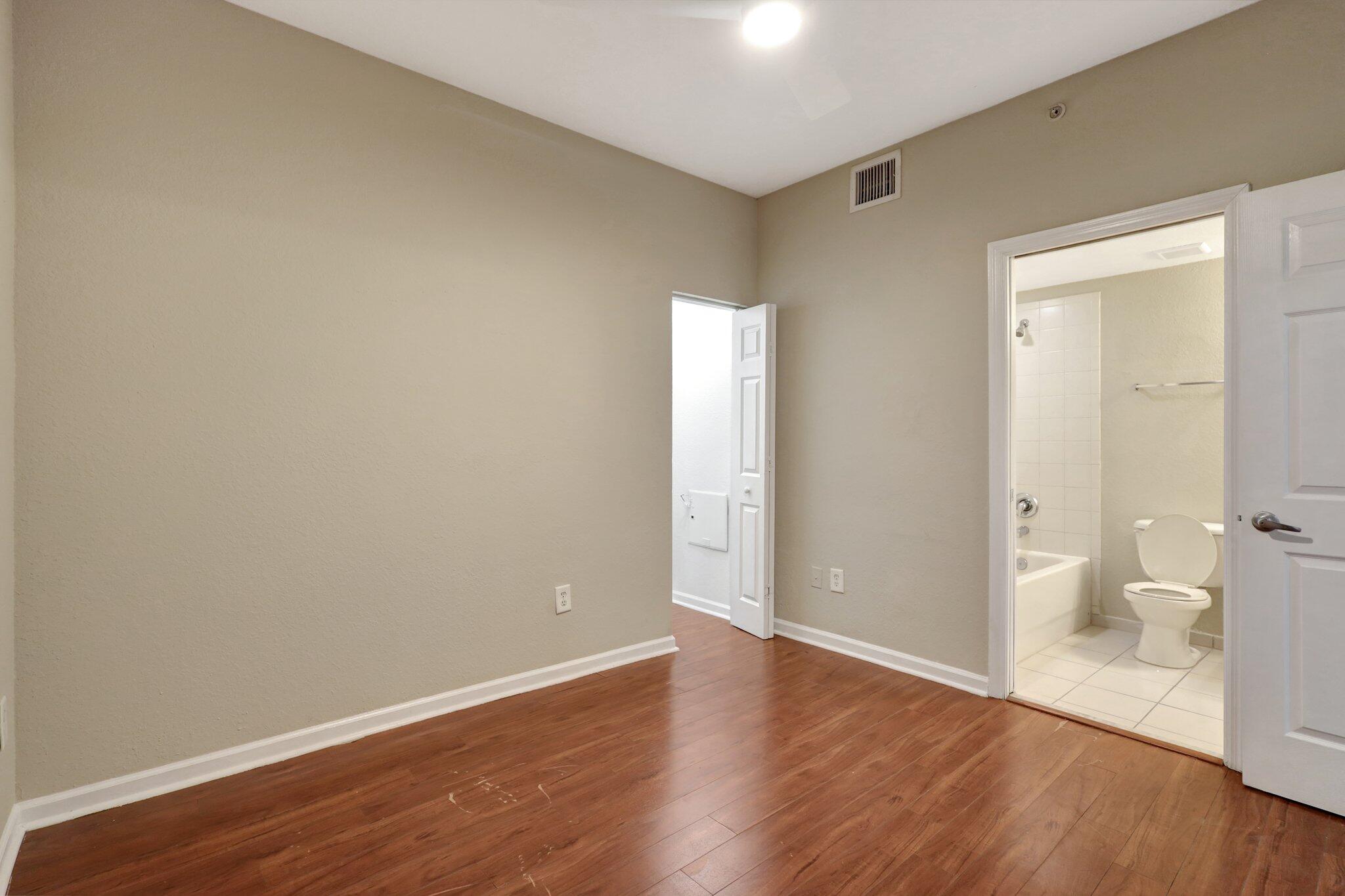 1964 Freeport Drive, Unit 1964 Riviera Beach, FL 33404 - Photo 14 of 20 a view of a room with wooden floor and a toilet