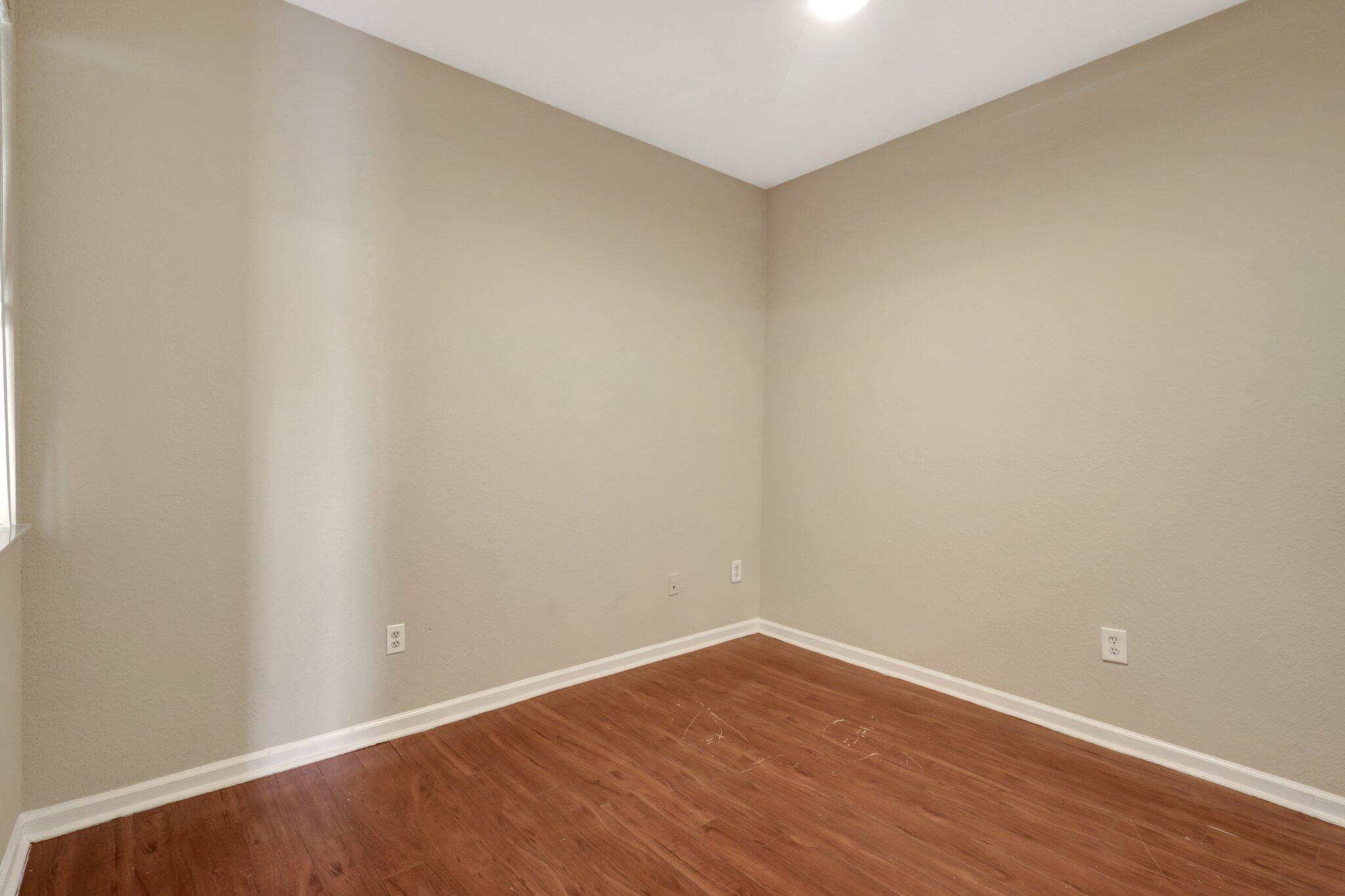 1964 Freeport Drive, Unit 1964 Riviera Beach, FL 33404 - Photo 15 of 20 a view of an empty room with wooden floor