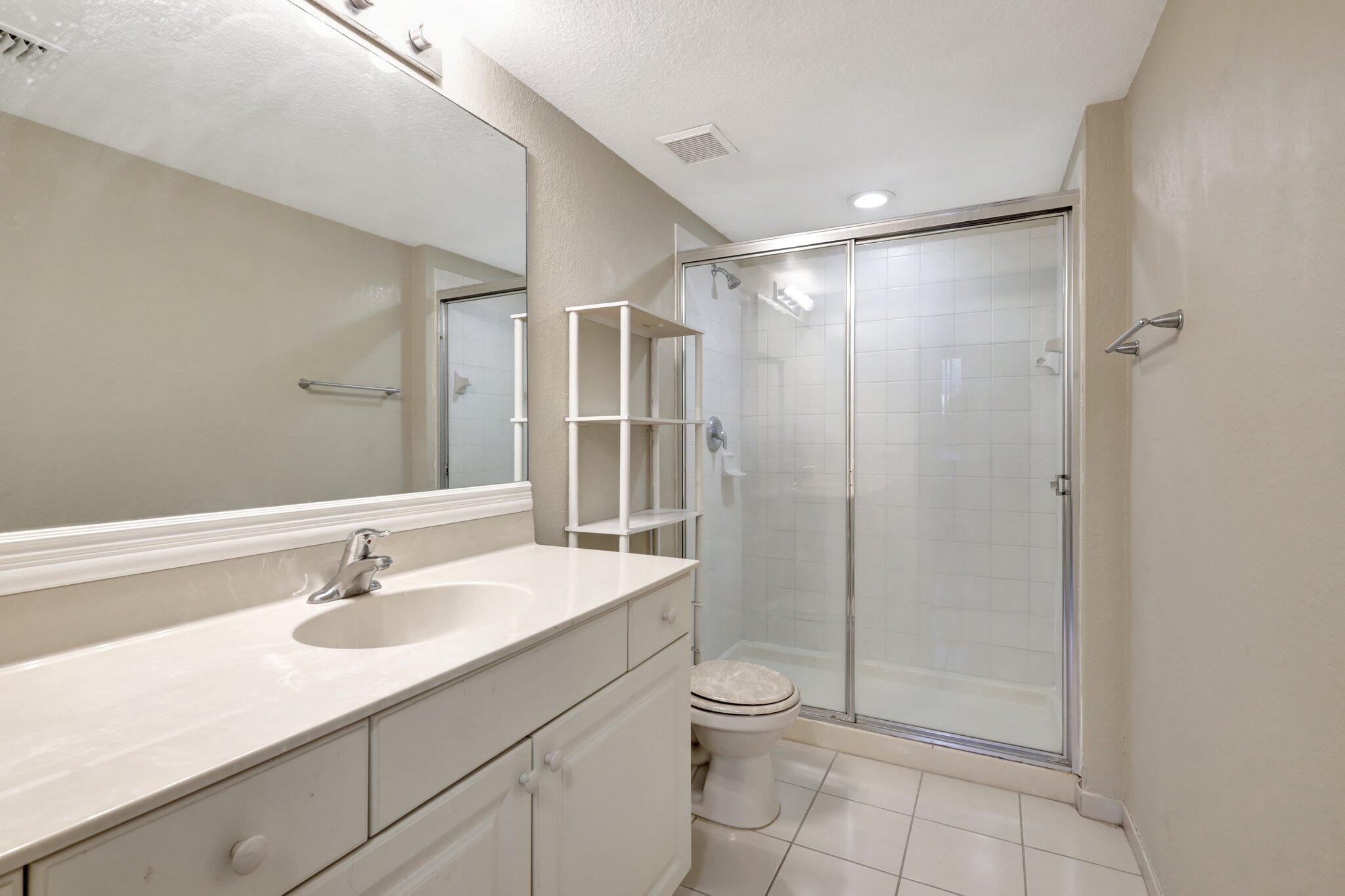 1964 Freeport Drive, Unit 1964 Riviera Beach, FL 33404 - Photo 16 of 20 a bathroom with a sink toilet and shower