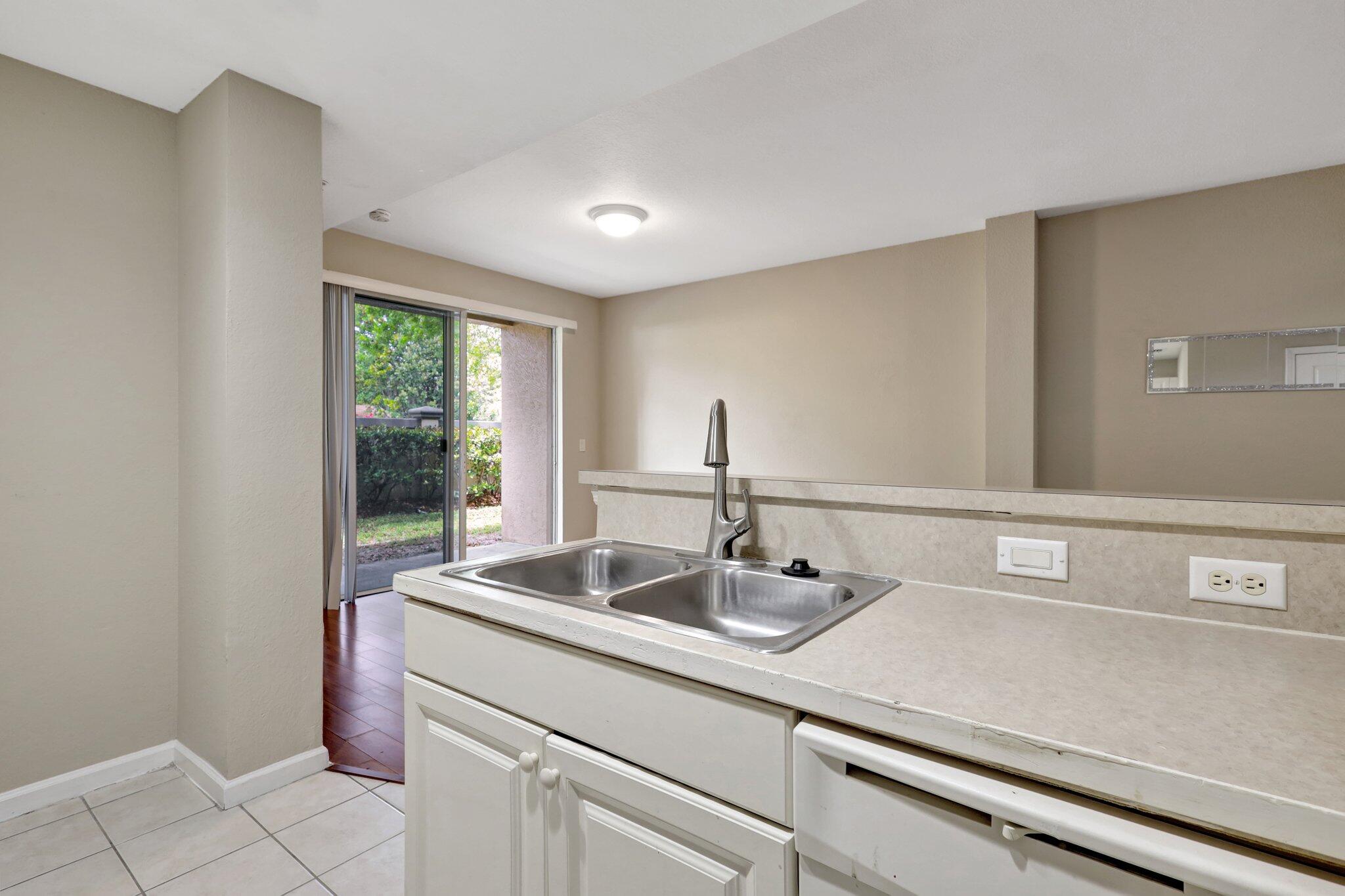 1964 Freeport Drive, Unit 1964 Riviera Beach, FL 33404 - Photo 7 of 20 a close view of sink and mirror