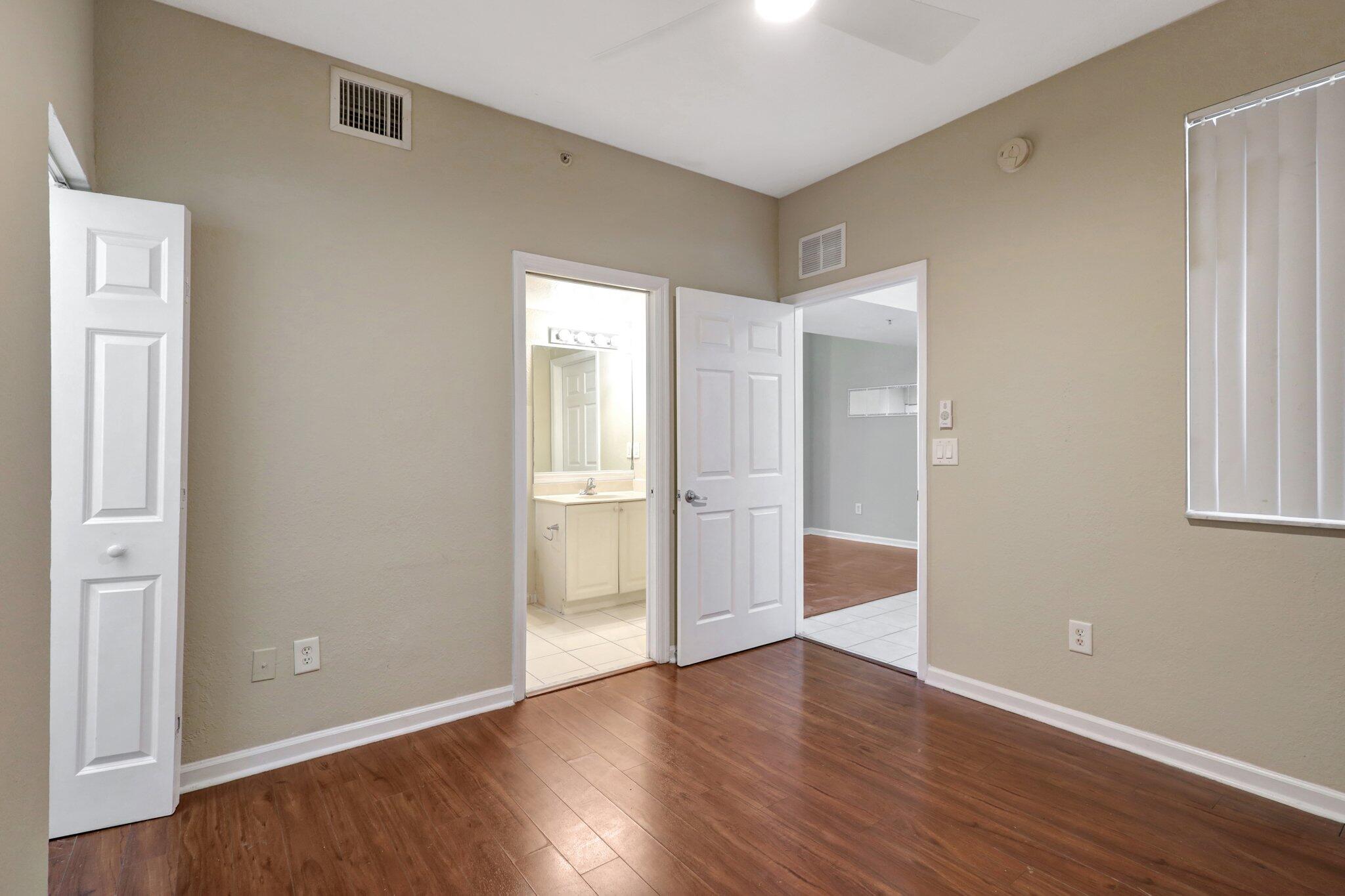 1964 Freeport Drive, Unit 1964 Riviera Beach, FL 33404 - Photo 10 of 20 a view of an empty room with wooden floor