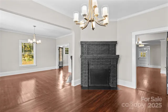a view of a livingroom with wooden floor and a ceiling fan