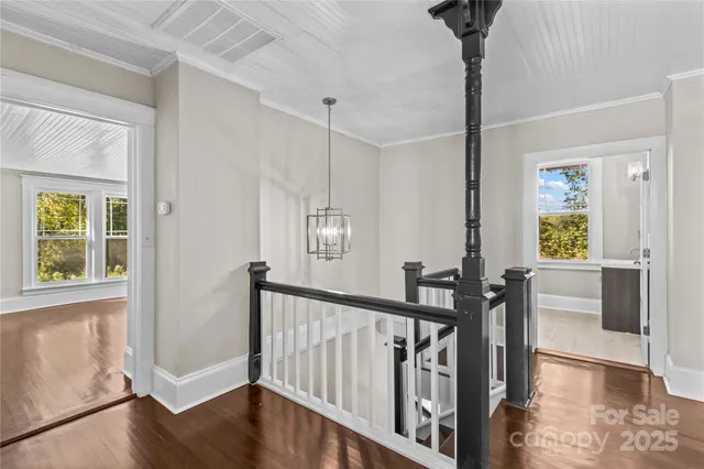 a view of an entryway with wooden floor and windows