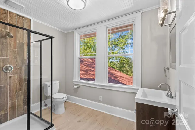 a bathroom with a toilet a sink and a window