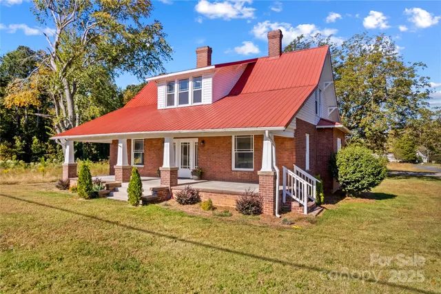 a front view of house with yard outdoor seating and barbeque oven