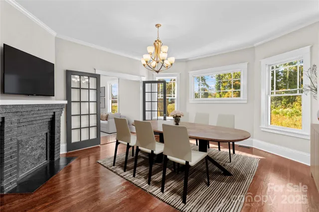 a view of a a dining room with furniture window and wooden floor