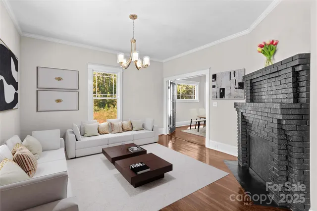 a living room with furniture and a chandelier