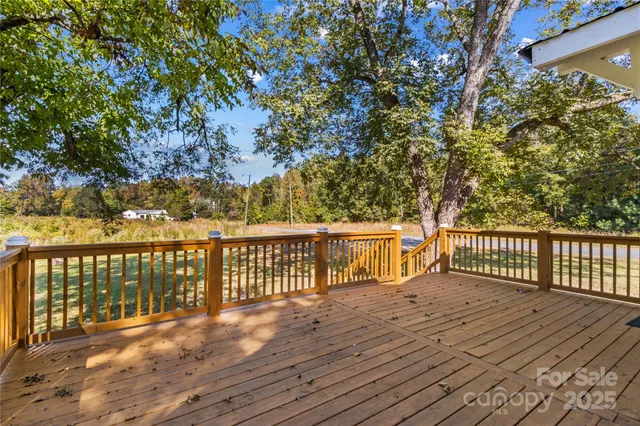 a balcony with wooden floor and fence