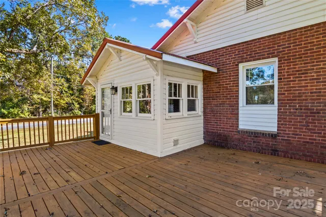 a view of a house with wooden deck