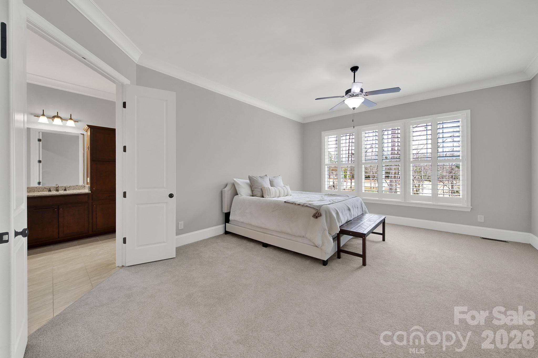 2112 Tatton Hall Road Fort Mill, SC 29715 - Photo 14 of 46 a spacious bedroom with a bed and a chandelier
