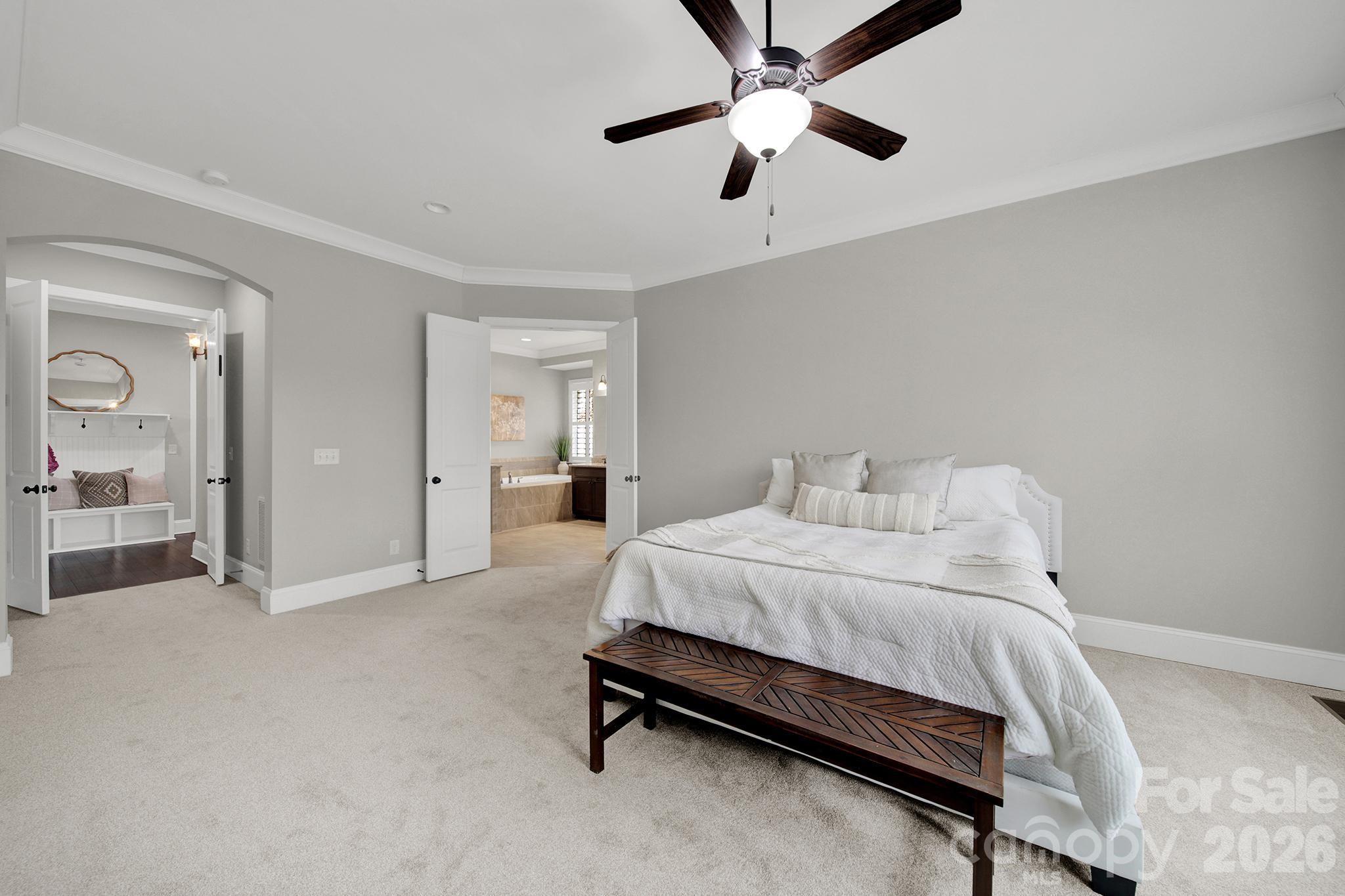 2112 Tatton Hall Road Fort Mill, SC 29715 - Photo 15 of 46 a spacious bedroom with a bed and a chandelier