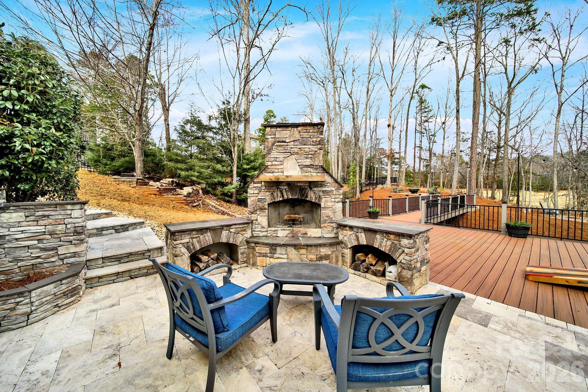 2112 Tatton Hall Road Fort Mill, SC 29715 - Photo 37 of 46 a view of a roof deck with couches table and chairs under an umbrella