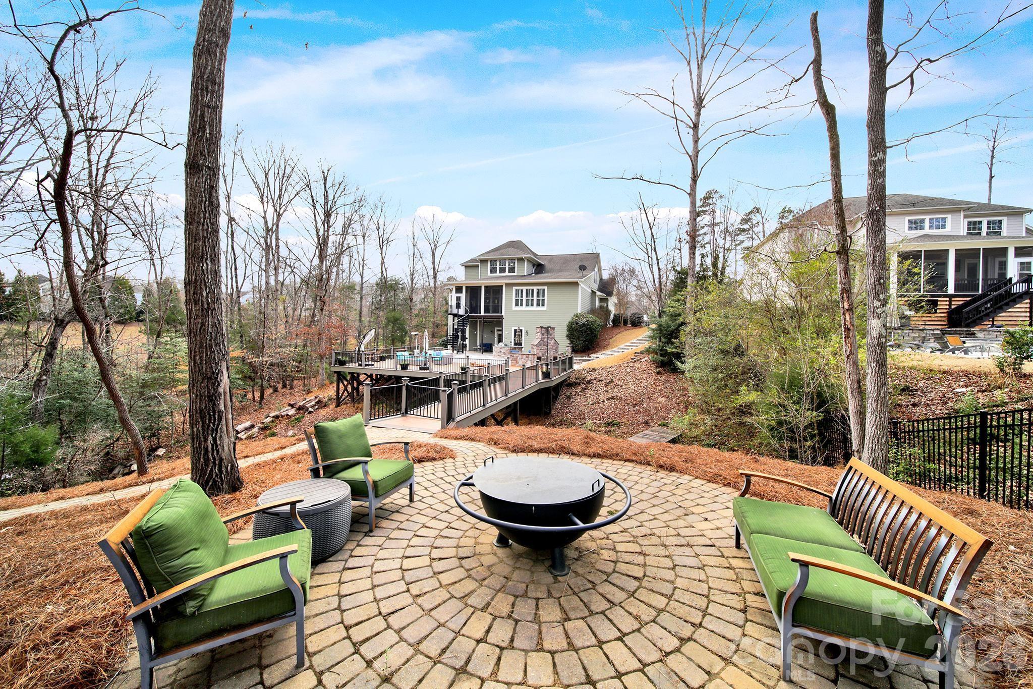 2112 Tatton Hall Road Fort Mill, SC 29715 - Photo 39 of 46 a view of a patio with couches chairs and a fire pit with a table and chairs