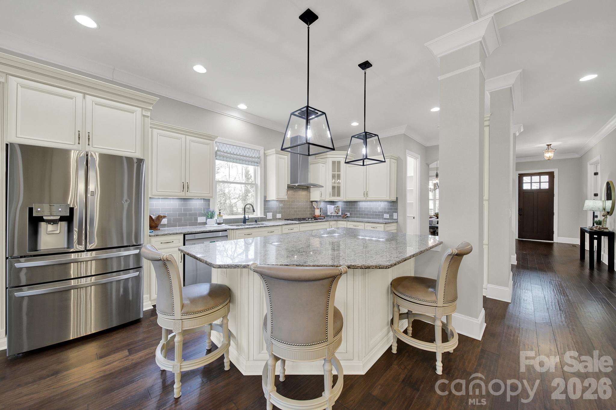 2112 Tatton Hall Road Fort Mill, SC 29715 - Photo 9 of 46 a kitchen with kitchen island granite countertop a sink cabinets and refrigerator