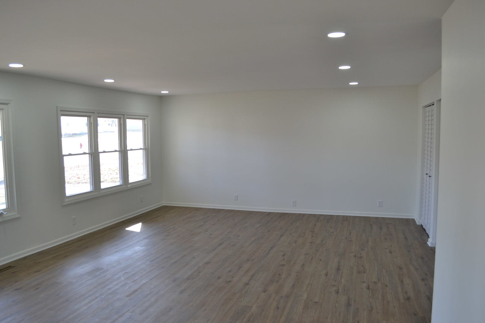 315 MacGregor Road Lockport, IL 60441 - Photo 3 of 24 an empty room with wooden floor and windows