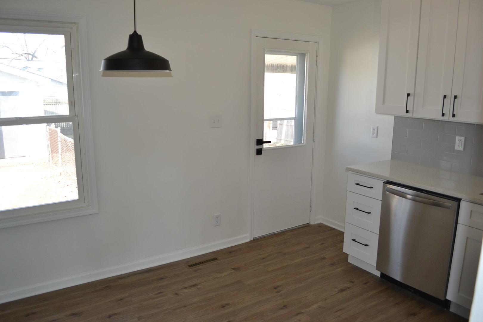 315 MacGregor Road Lockport, IL 60441 - Photo 8 of 24 an empty room with wooden floor cabinet and windows