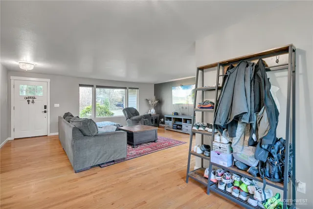 a living room filled with furniture and a wooden floor