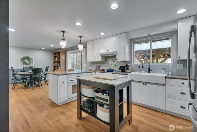 a kitchen with a sink stove and cabinets