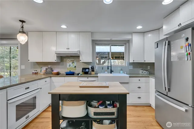 a kitchen with a sink stove and refrigerator