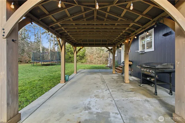 a view of a porch with furniture and yard