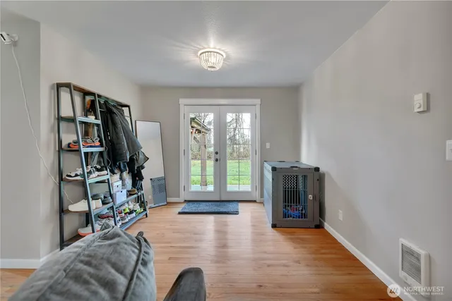 a view of a livingroom with furniture hardwood floor and hallway