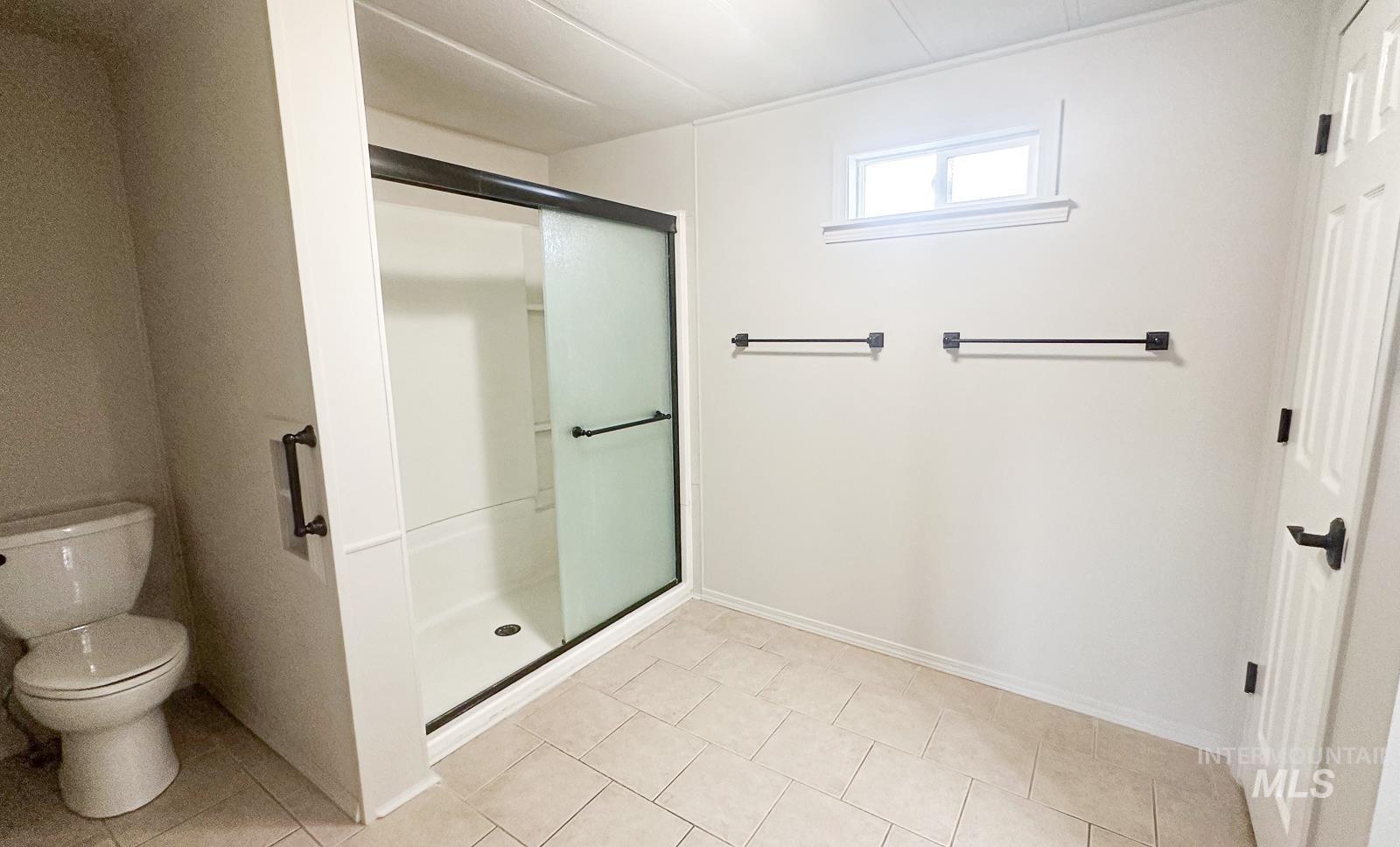 1200 Artesian Road Eagle, ID 83616 - Photo 11 of 18 Bathroom featuring a shower stall and light tile patterned flooring