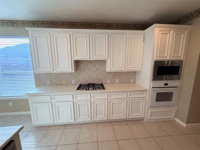 a kitchen with white cabinets
